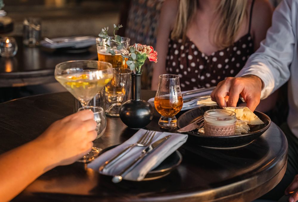 Couple of people enjoying drinks and finger food